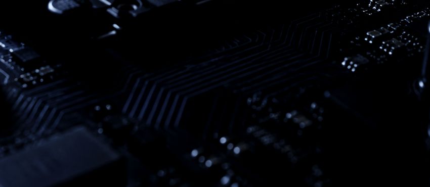 Macro photograph of copper traces fanning out across a circuit board.