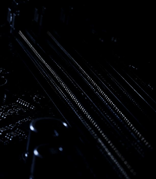 Macro photograph of memory slot contacts on a motherboard.